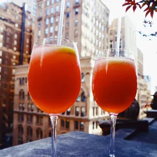 two glasses of orange juice on a table