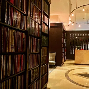 a library with a circular light fixture
