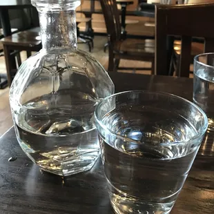 a glass of water and a decanter