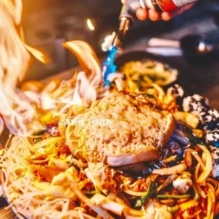 a plate of food being cooked on a fire