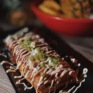 a taco roll with a pineapple in the background