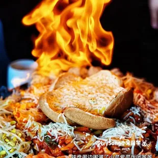 a plate of spaghetti and bread on fire