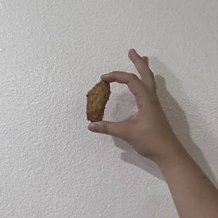 a hand holding a piece of food