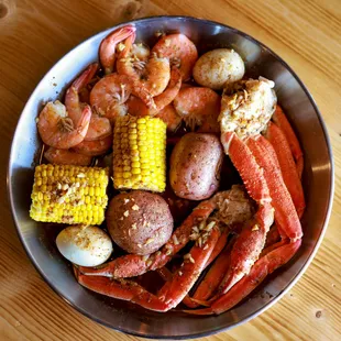 crab legs, potatoes, corn, and corn on the cob