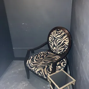 a zebra print chair and a side table