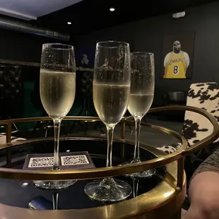 three glasses of champagne on a table