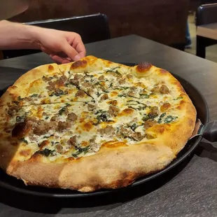 Build your own white pizza with sausage and basil