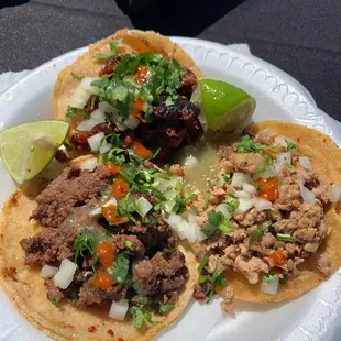 One al pastor, one chicken and one carne asada street taco.