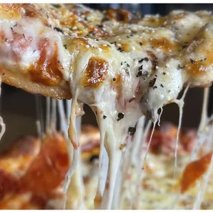 a slice of pizza being lifted by a spatula