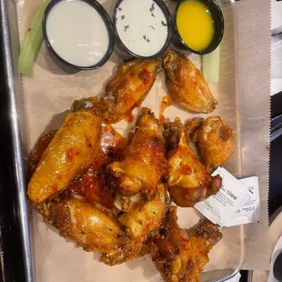 Thai chili wings with bleu cheese, ranch, &amp; garlic butter.