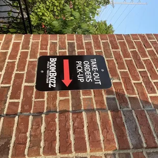 a street sign on a brick wall