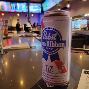 a can of beer on a bar
