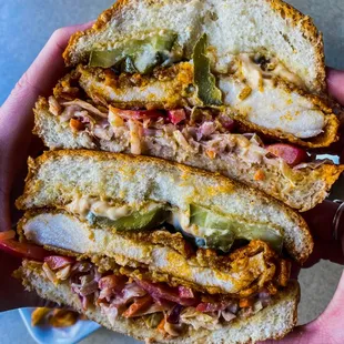 a hand holding a sandwich