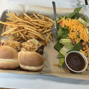 Sliders with salad and fries.