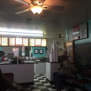 a woman sitting in a diner
