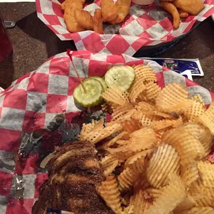 Didn't wait to take photo until more than halfway done Patty melt with chips, onion petal appetizer.
