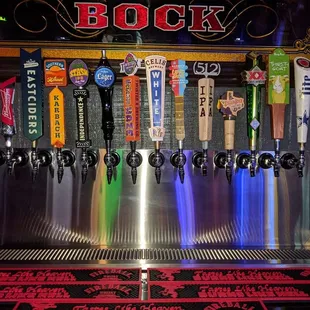 a row of beer taps in a bar