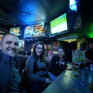 a group of people sitting at a bar