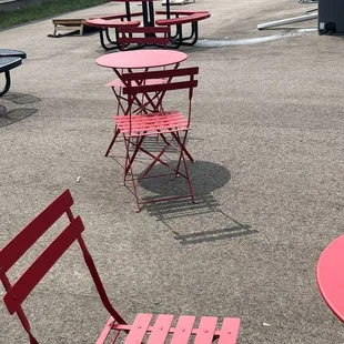 red chairs and tables in a parking lot