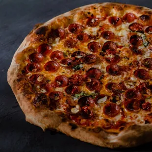 a pepperoni pizza on a table