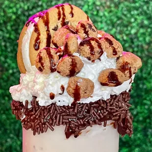 a milkshake topped with cookies and sprinkles