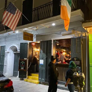 a group of people standing outside of a restaurant