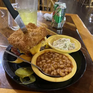 BBQ burger with bacon between two slices of fried Mac &amp;  cheese, baked beans and coke slaw