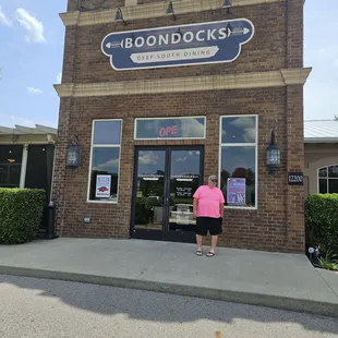 a woman standing in front of a building