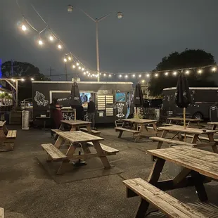 a food truck and picnic tables