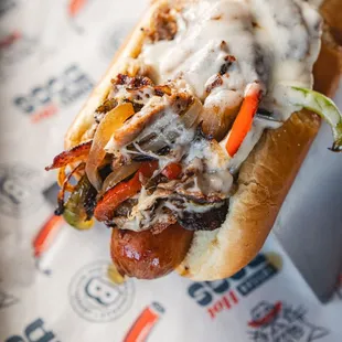 Cheesesteak Dog
A juicy hot dog loaded with tender, seasoned steak, sautéed peppers and onions, and topped with melted provolone cheese.