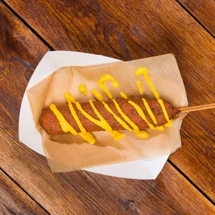 Hand-Dipped Corndog
Each of our corndogs is hand-dipped to order, creating that perfect crispy coating around a juicy dog. Fun, comforting,