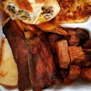 Pictured clockwise from top left: cheesy bierock, tater wedges, corn pudding, burnt ends, ribs, buttered toast. Ahhhmazing.