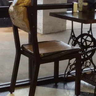 Chairs made from scraps from when the sawmill squares up logs.  They are very heavy!  Bases of some tables are from old sewing machines.