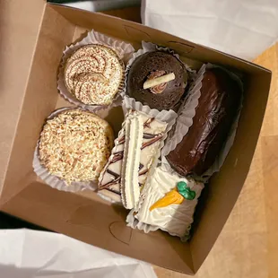 Top: Tiramisu, Cheesecake Dome, an eclair w/ Bavarian cream Bottom: Coconut cream tart, Napoleon, Carrot cake