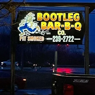 ows a sign for bootleg bar - b - q