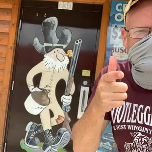 a man wearing a mask and giving a thumbs up