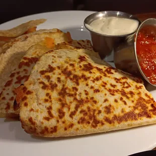 a plate of quesadillas and salsa