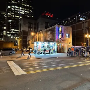 a group of people waiting to cross the street