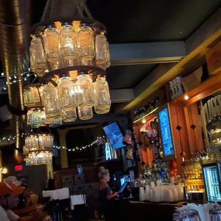 a bar with a chandelier hanging from the ceiling