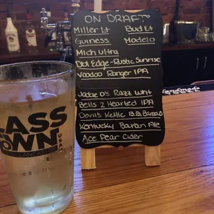 a glass of beer and a menu