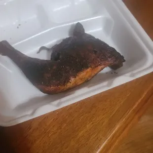 a chicken in a styrofoam container