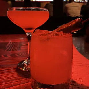 two cocktails on a bar