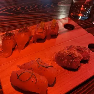 a variety of sushi on a wooden board