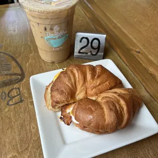 Bacon egg and cheese croissant sandwich plus a small late.