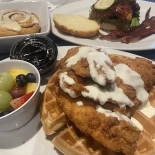 Cinnamon roll (top left) Sweet and spicy chicken biscuit sandwich (top right) Chicken and waffles