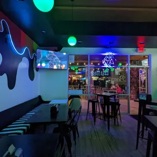 the interior of a restaurant with neon lights