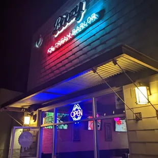 the front of a restaurant lit up at night