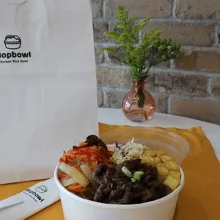 a bowl of food and a fork on a table