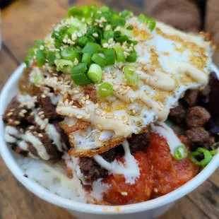 Korean bulgogi beef bowl with avocado and fried egg