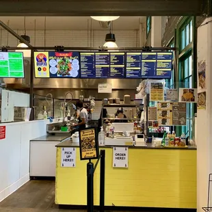 the inside of a restaurant with a yellow counter